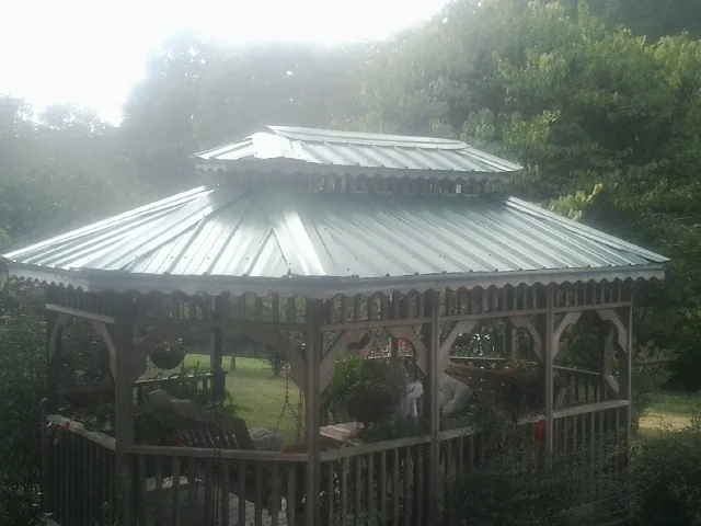Two tier green metal roof on a garden gazebo in Hermitage